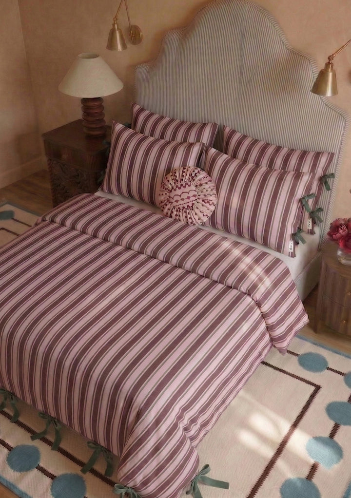 Bed dressed with TBCo Cotton Duvet Cover & Pillowcases Set in Pink Stripe featuring soft pink and cream stripes with green ribbon ties