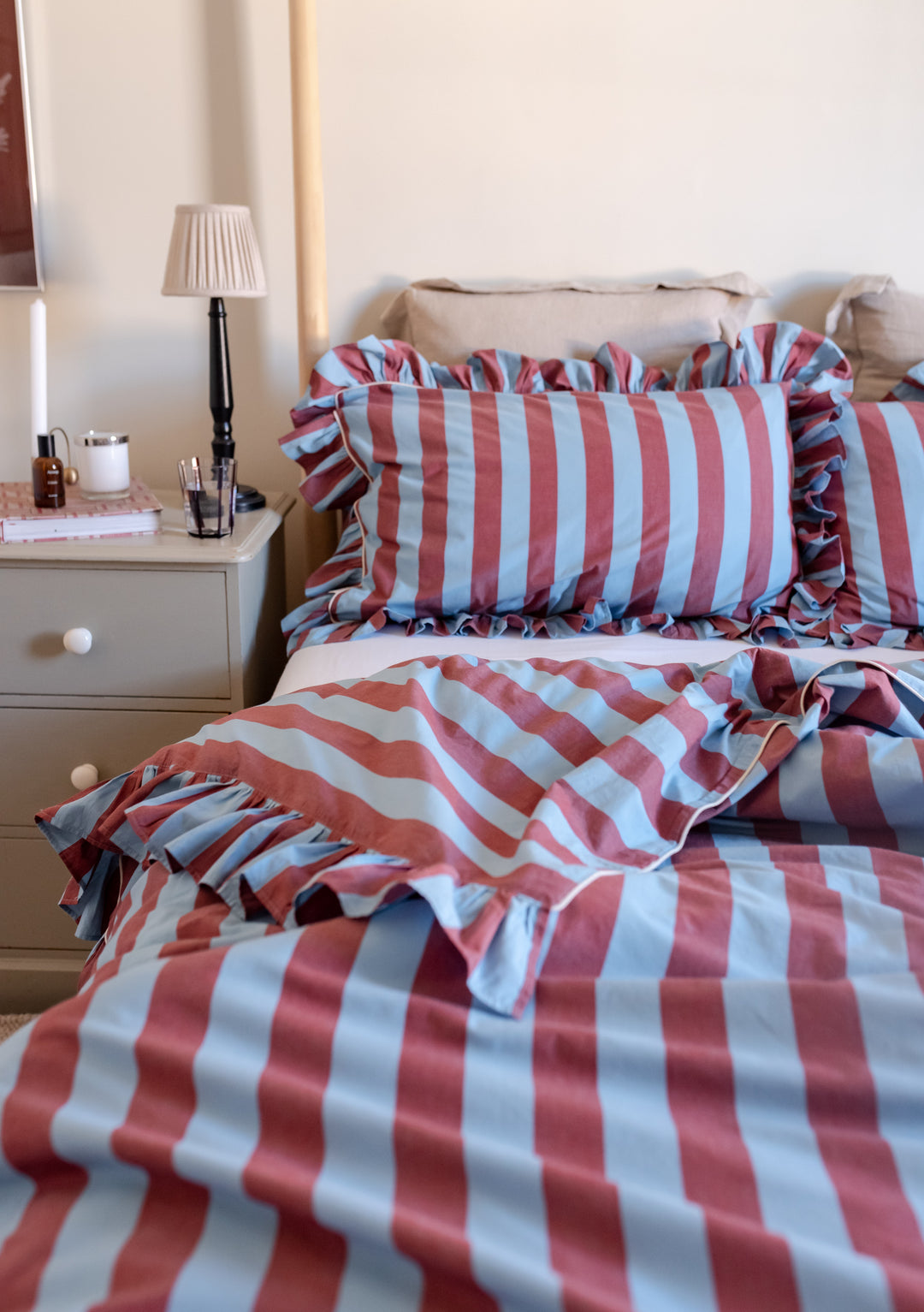 TBCo Cotton Duvet Cover with blue and red stripes featuring ruffled edges on a cosy bed with matching pillowcases