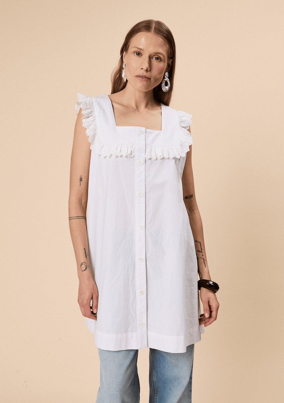 Model wearing TBCo Cotton Broderie Sleeveless Dress in White made with natural and recycled fibres, Certified B-Corp, women-founded, designed to make an impact