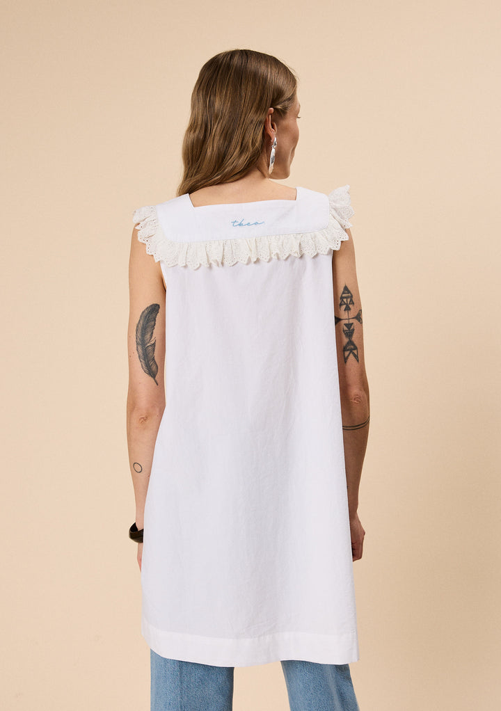 Back view of woman wearing TBCo Cotton Broderie Sleeveless Dress in White with natural and recycled fibres, Certified B-Corp, women-founded, designed to make an impact