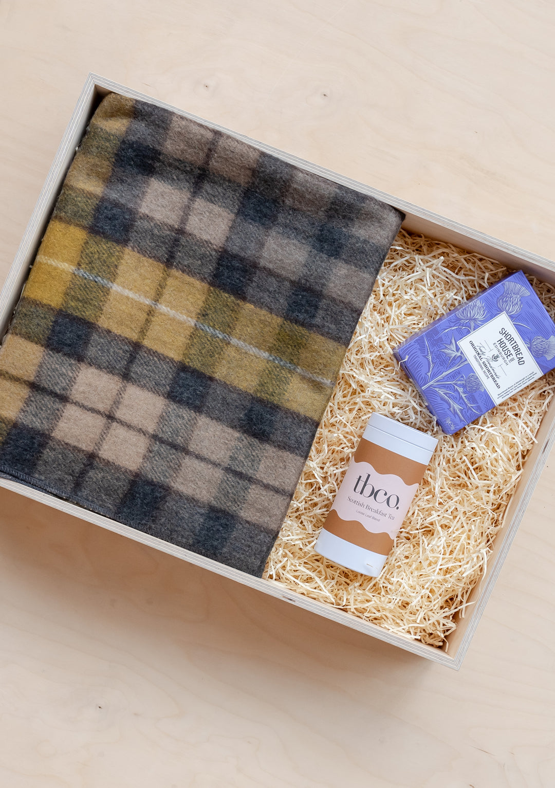 TBCo Ready-Made Scottish Treats Gift Box featuring tartan wool blanket, shortbread, and tea in branded presentation box