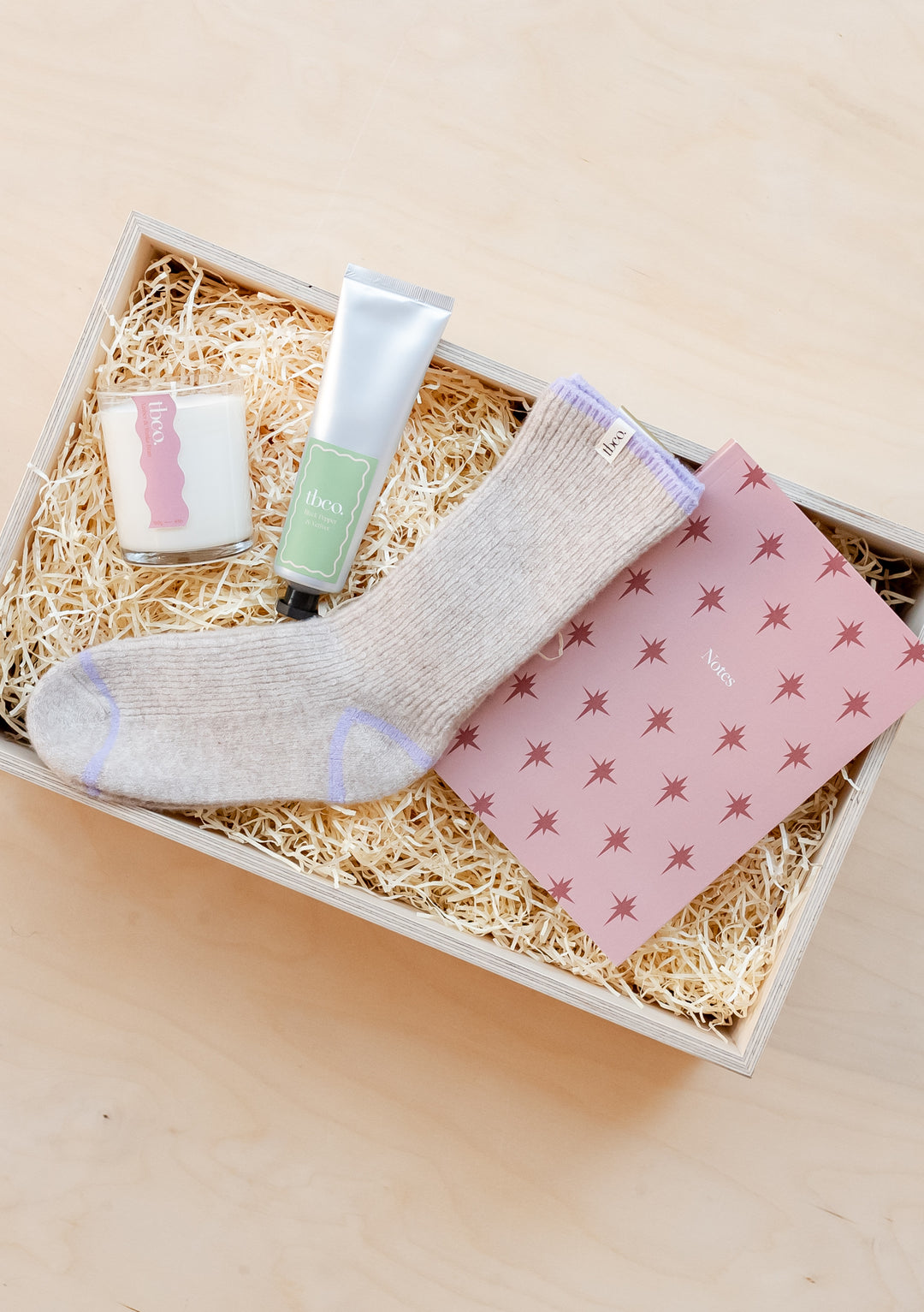 TBCo Sweet Dreams Gift Box showcasing cosy socks, pink notebook, candle and hand cream in sustainable packaging