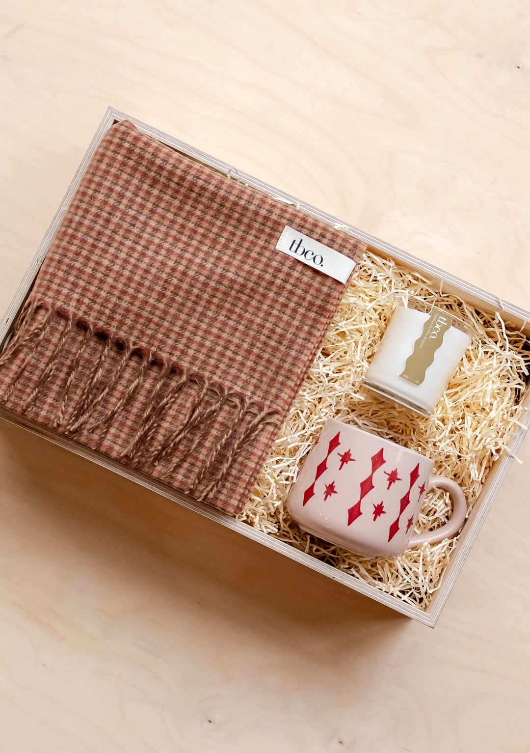 TBCo Ready-Made Winter Warmth Gift Box featuring camel tweed scarf, candle and celestial mug nestled in straw filling