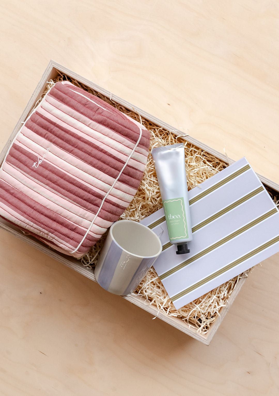 TBCo Rest & Refresh Gift Box featuring striped washbag, ceramic mug, hand cream and notebook arranged in presentation box