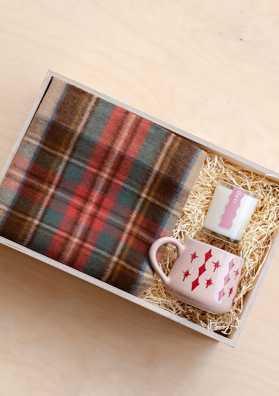 TBCo Ready-Made Tartan Gift Box featuring lambswool scarf, pink ceramic mug and candle nestled in straw-filled presentation box