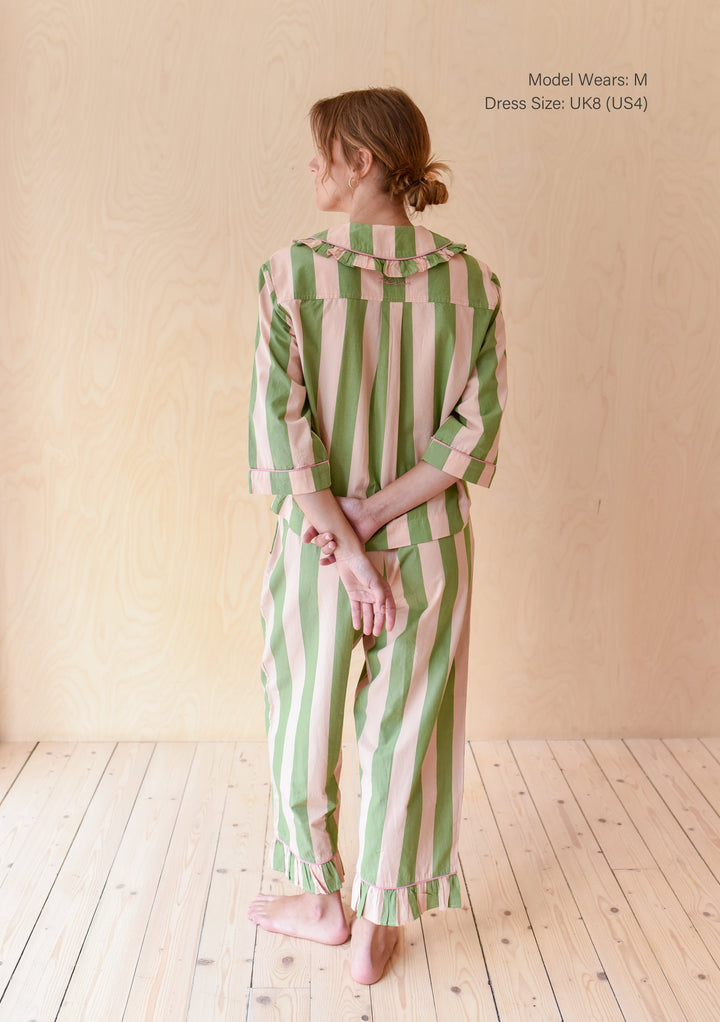 Back view of TBCo Cropped Cotton Pyjamas in Green Stripe with ruffled collar and cuffed sleeves on wooden floor background