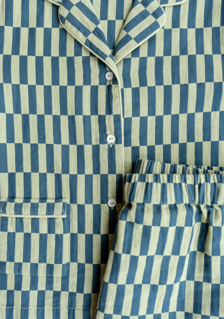 Close-up view of TBCo Cotton Kids Pyjamas in green and cream checkerboard pattern showing collar, buttons and pocket detail