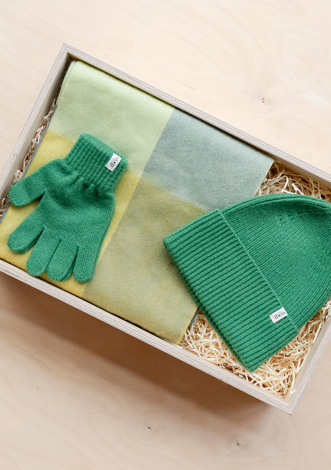 TBCo Kids Gift Box featuring green winter accessories and pastel coloured fabric in a wooden presentation box