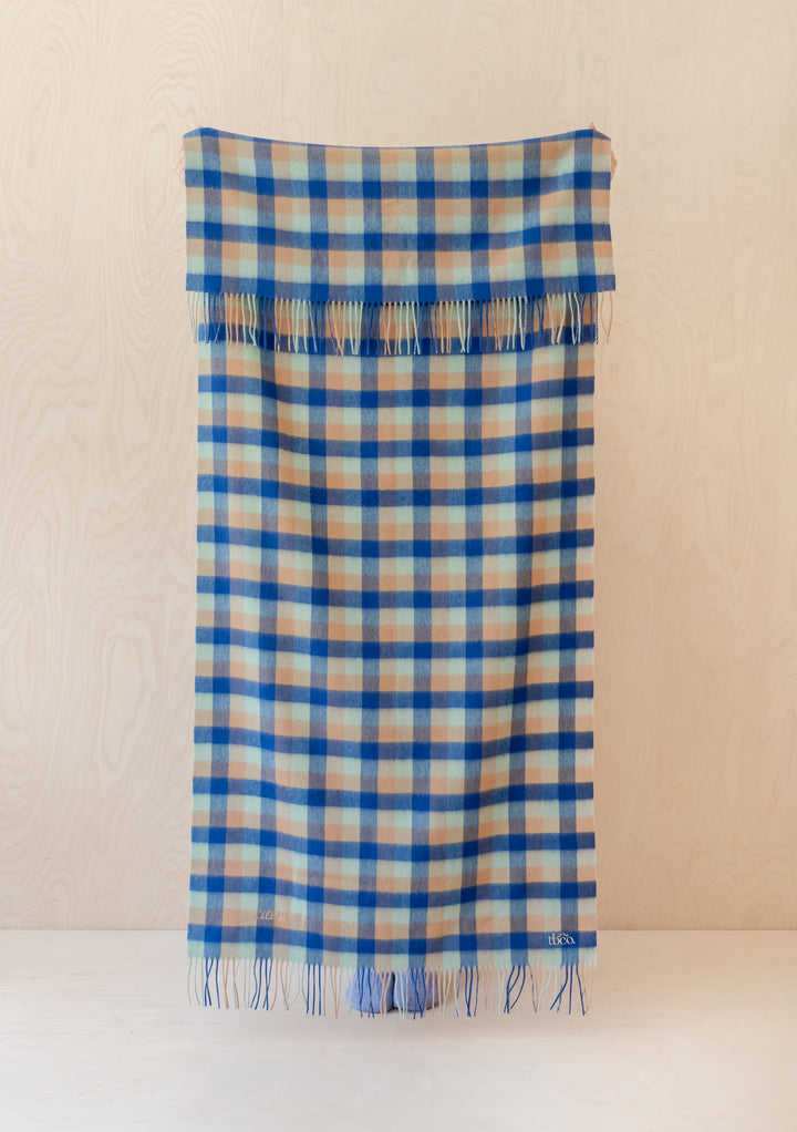 TBCo Lambswool Kids Blanket in blue, green and camel gingham pattern with fringe detail, displayed flat against cream background