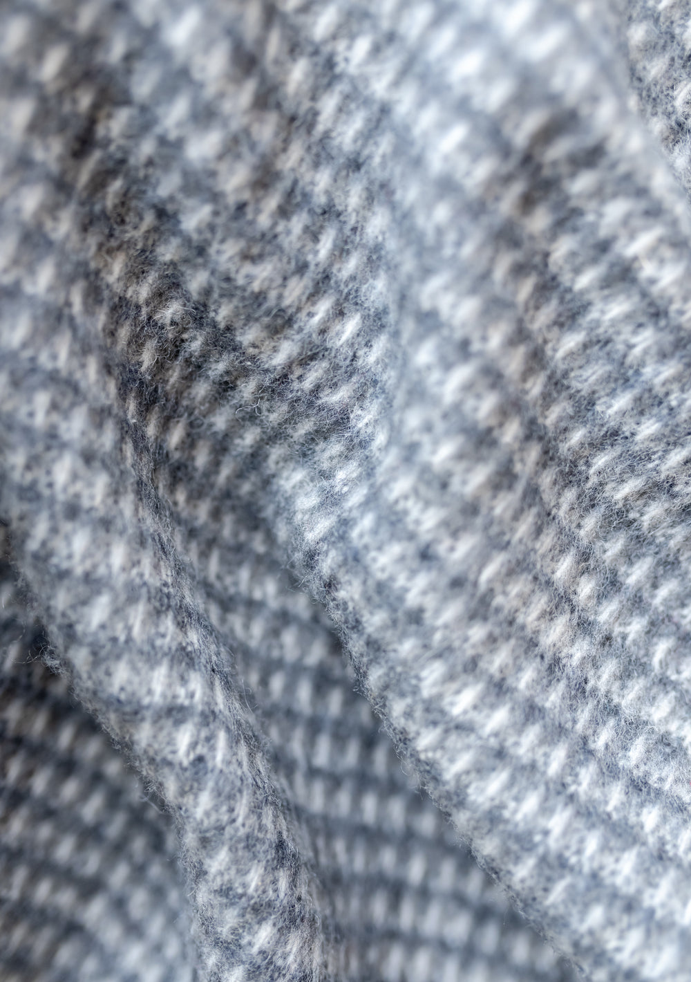 Close-up texture detail of TBCo Recycled Wool Extra Large Blanket in Charcoal Waffle showing soft woven pattern