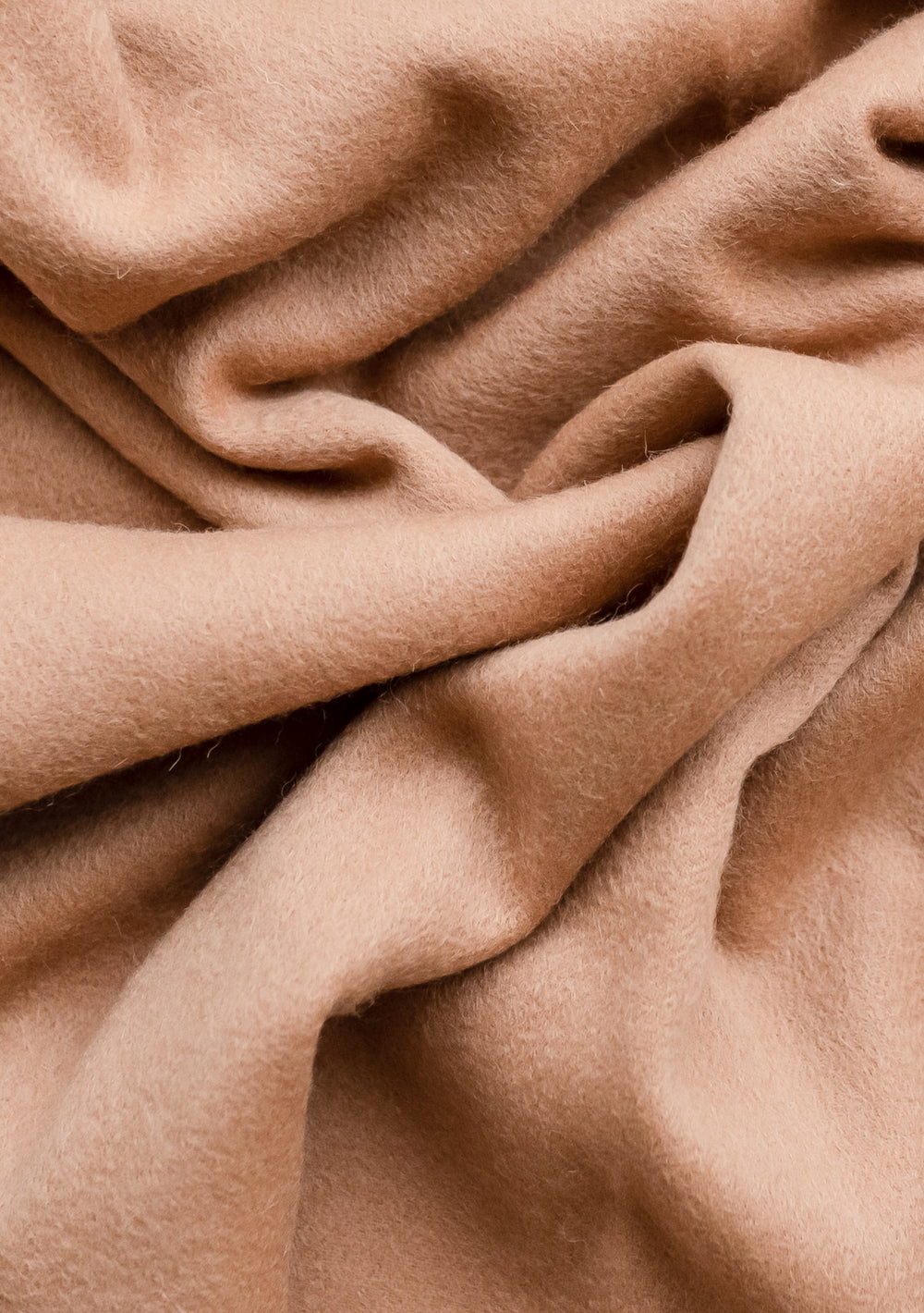 Luxurious TBCo Cashmere Small Blanket in Camel showcasing soft, draped fabric texture with gentle folds and warm camel colouring