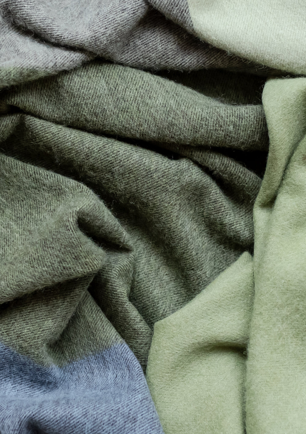 TBCo Lambswool Blanket in Green Frame Check featuring soft folds and textured weave pattern in sage green and blue tones