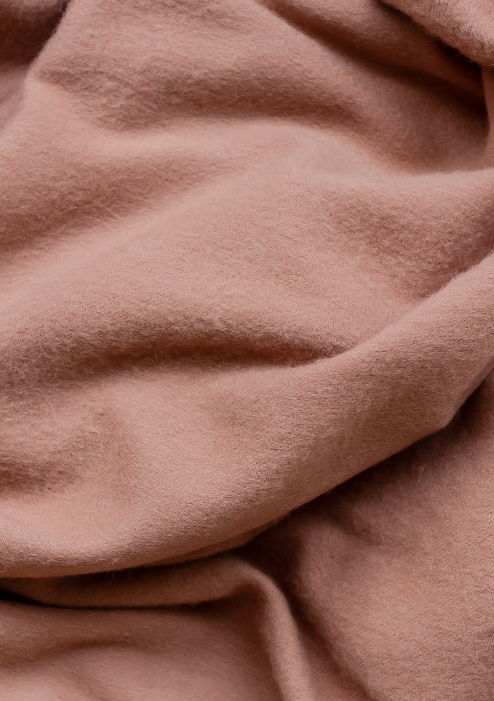 Soft, luxurious TBCo Lambswool Scarf in Blush pink showcasing the natural texture and gentle drape of premium wool fabric