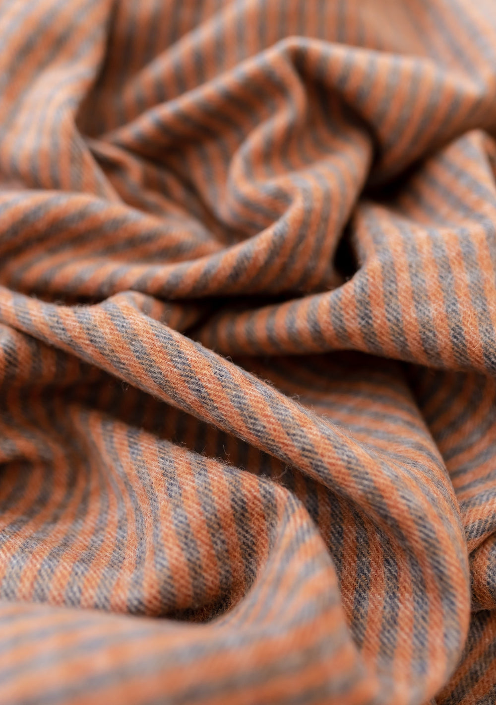 Close-up texture detail of TBCo Coffee Twill Check Lambswool Blanket showing diagonal grey and rust-coloured stripes