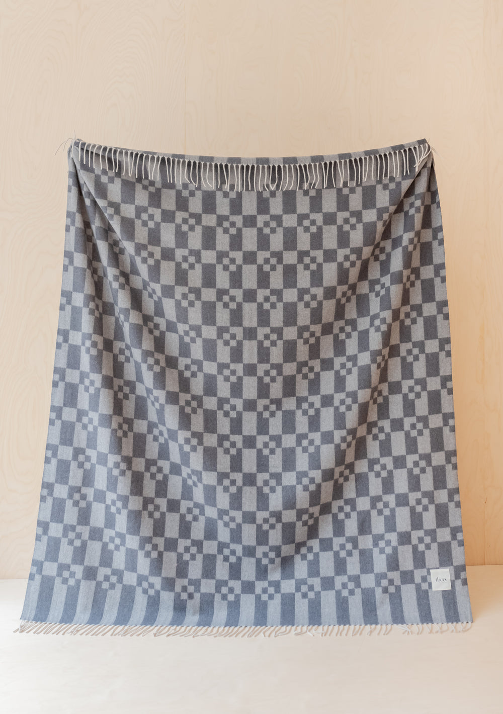 TBCo Grey Geometric Block Cashmere & Merino Blanket featuring checkered pattern with fringed edges in luxurious grey tones