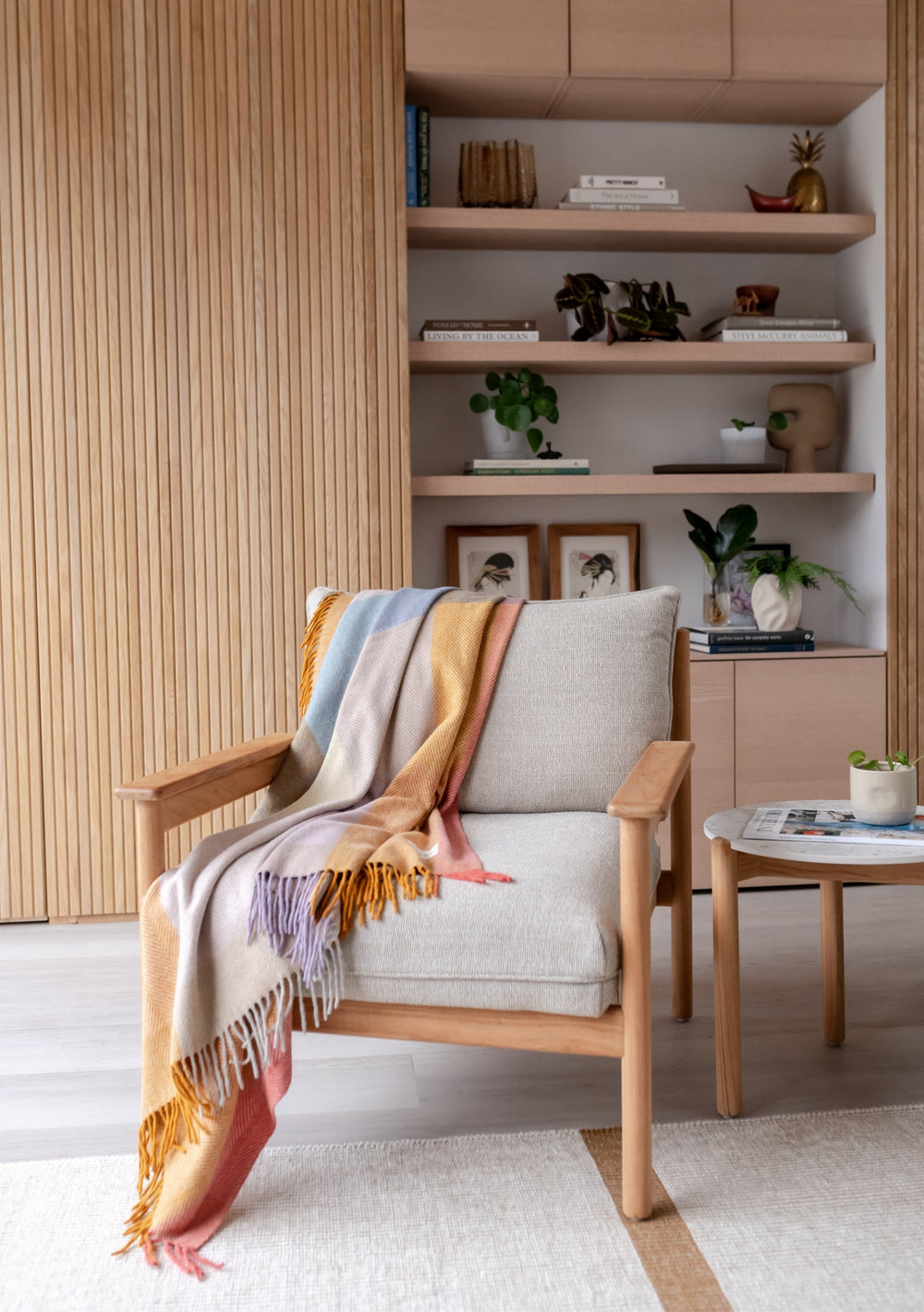 TBCo Recycled Wool Blanket in Mustard Frame Check draped over cream armchair, displaying pastel blue and lilac check pattern