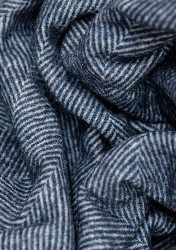 Close-up texture detail of TBCo Recycled Wool Small Blanket in Navy Herringbone pattern showing woven wool fibres