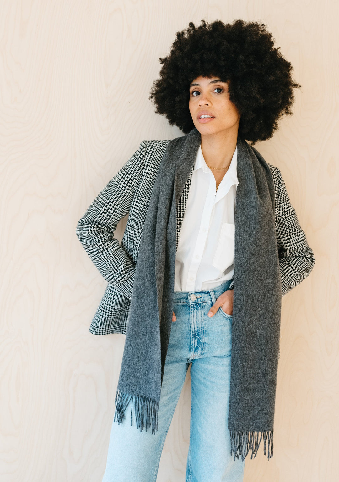 TBCo Lambswool Scarf in Charcoal Melange styled with plaid blazer and light denim jeans against neutral backdrop