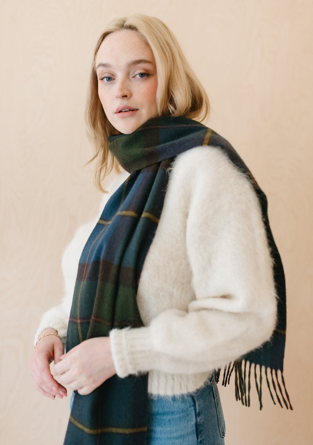 TBCo Macleod of Harris Antique Tartan Lambswool Scarf styled with white sweater, showcasing traditional plaid pattern and fringe detail