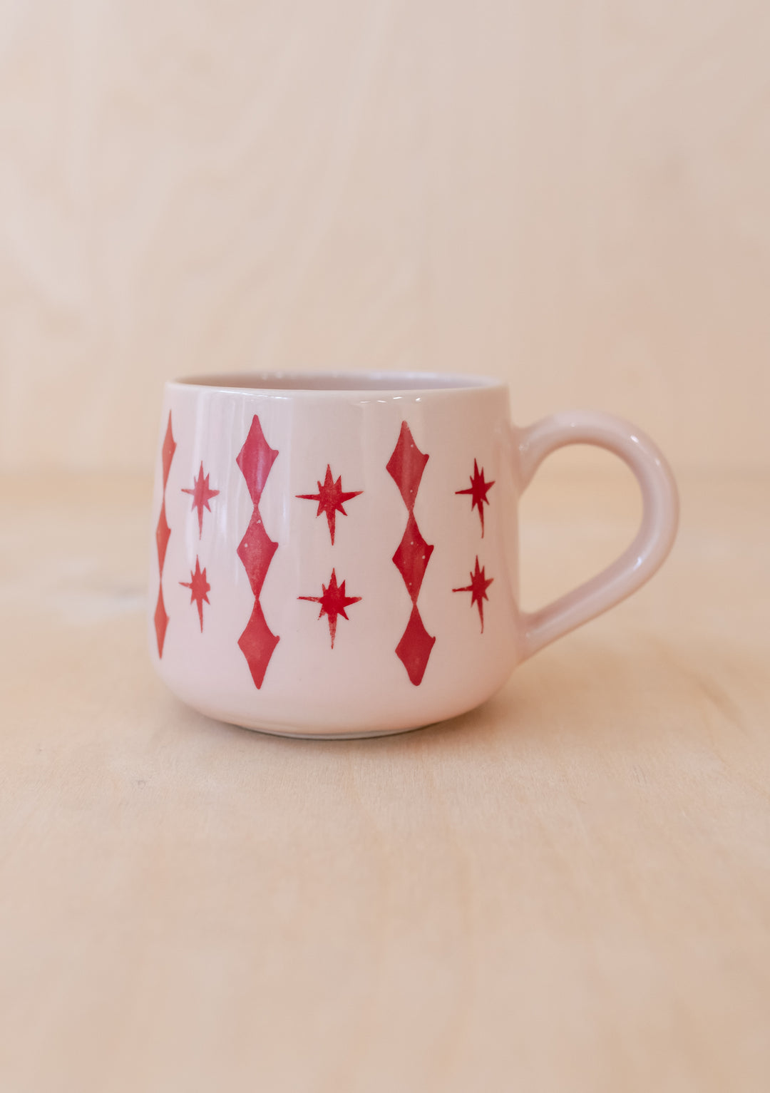 TBCo Celestial Pink Mug featuring hand-painted pink stars and diamond patterns on white ceramic with curved handle