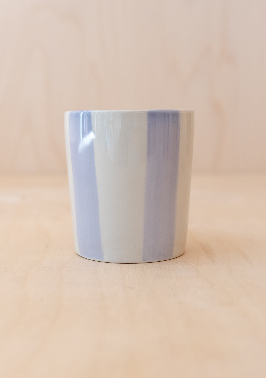 Handcrafted TBCo Lilac Stripe Mug featuring vertical lilac and white stripes on ceramic, handleless design with matte finish