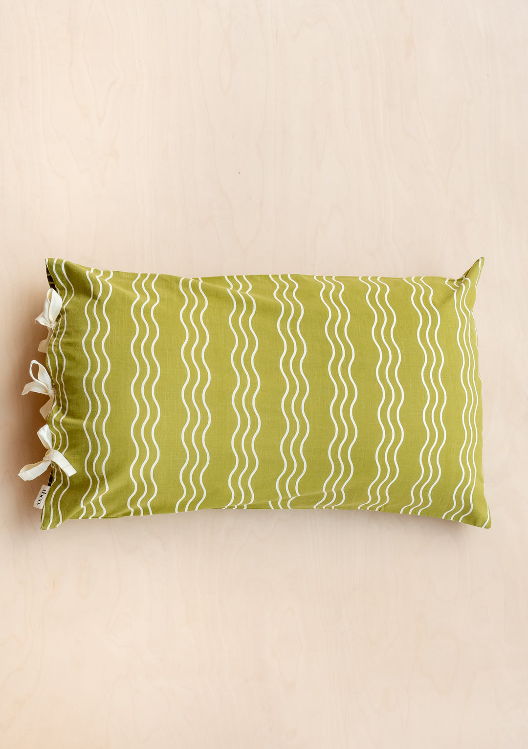 TBCo Cotton Pillowcase in Olive Wave pattern with cream stripes and side tie closures, photographed on beige background