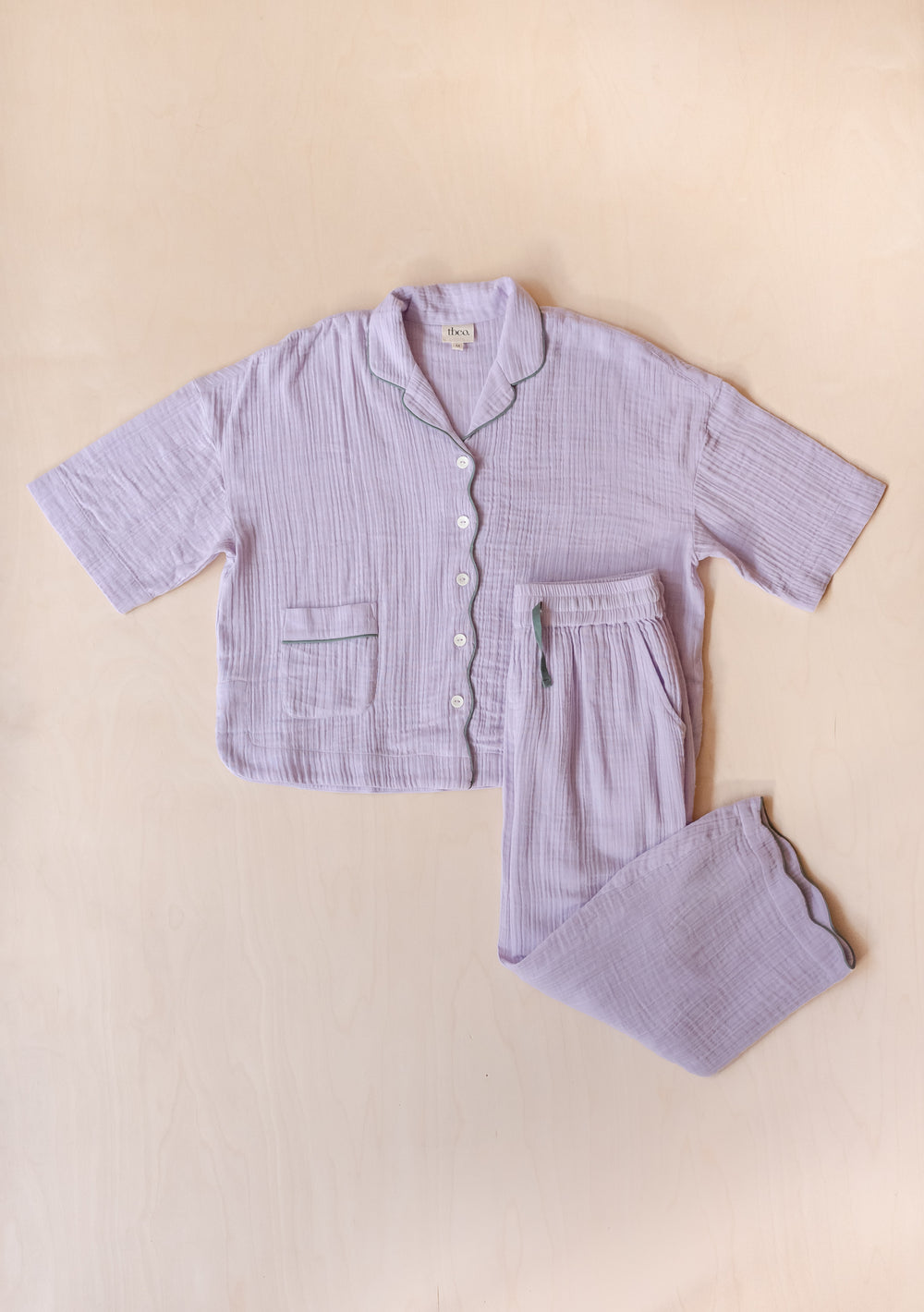 TBCo Cotton Pyjamas in Lilac featuring cropped sleeves, scalloped hem trousers, dual pockets and crinkle gauze fabric