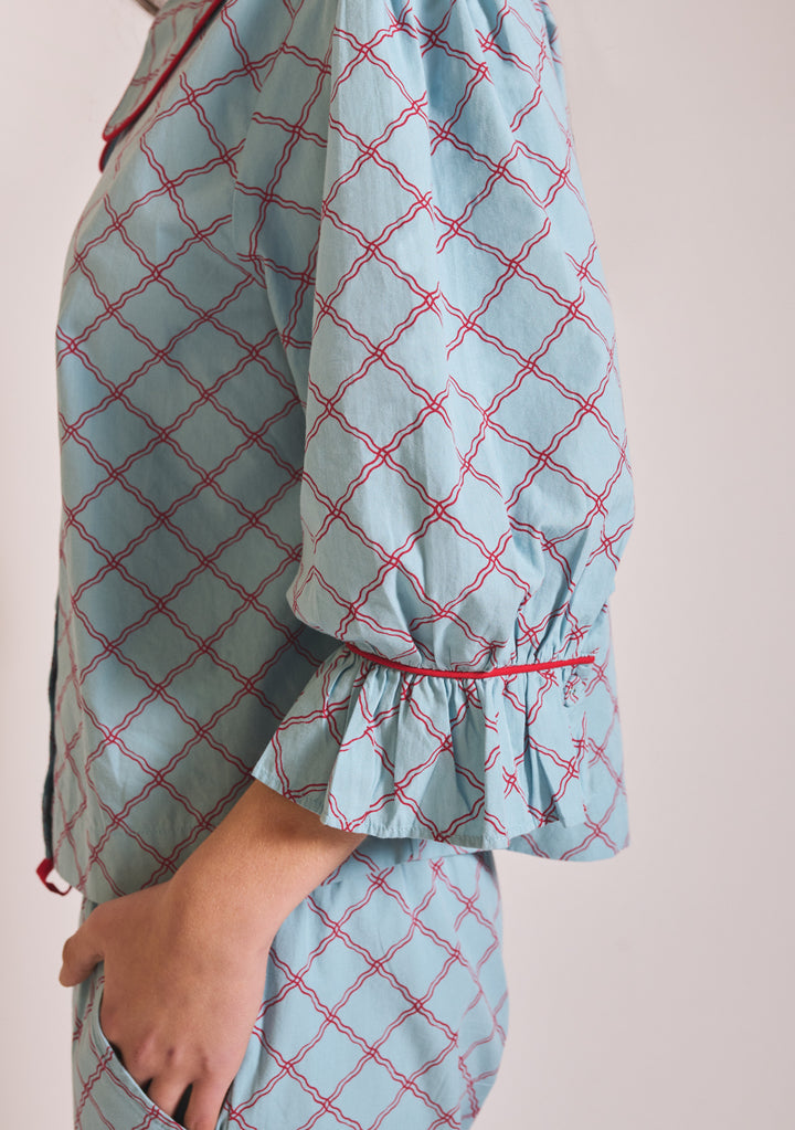 Close-up portrait shot of TBCo Cropped Cotton Pyjamas in Blue Lattice showing ruched sleeve detail, gallery position 5