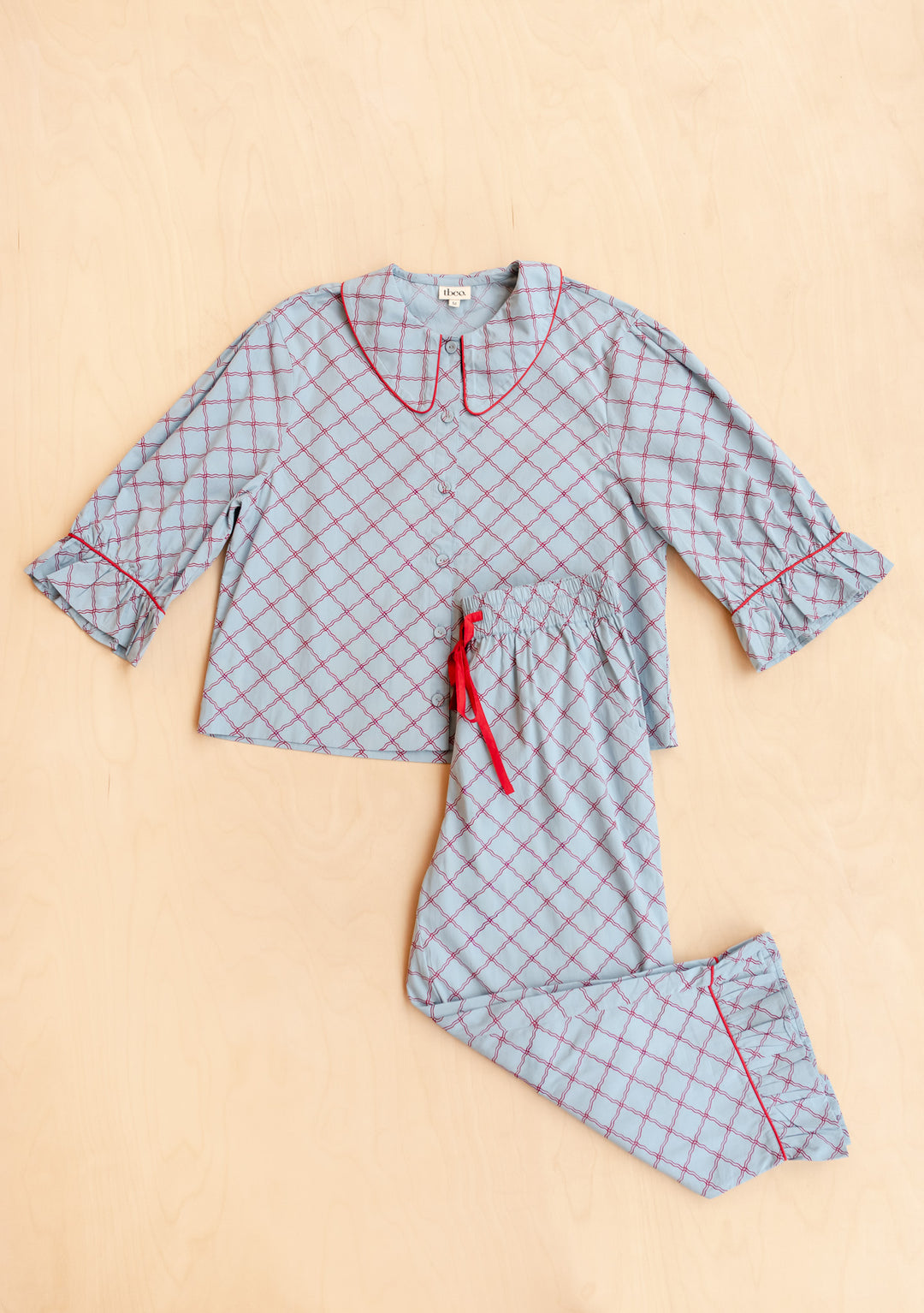 Cropped Cotton Pyjamas in Blue Lattice from TBCo laid flat, gallery image 7 with red trim details on cotton poplin fabric