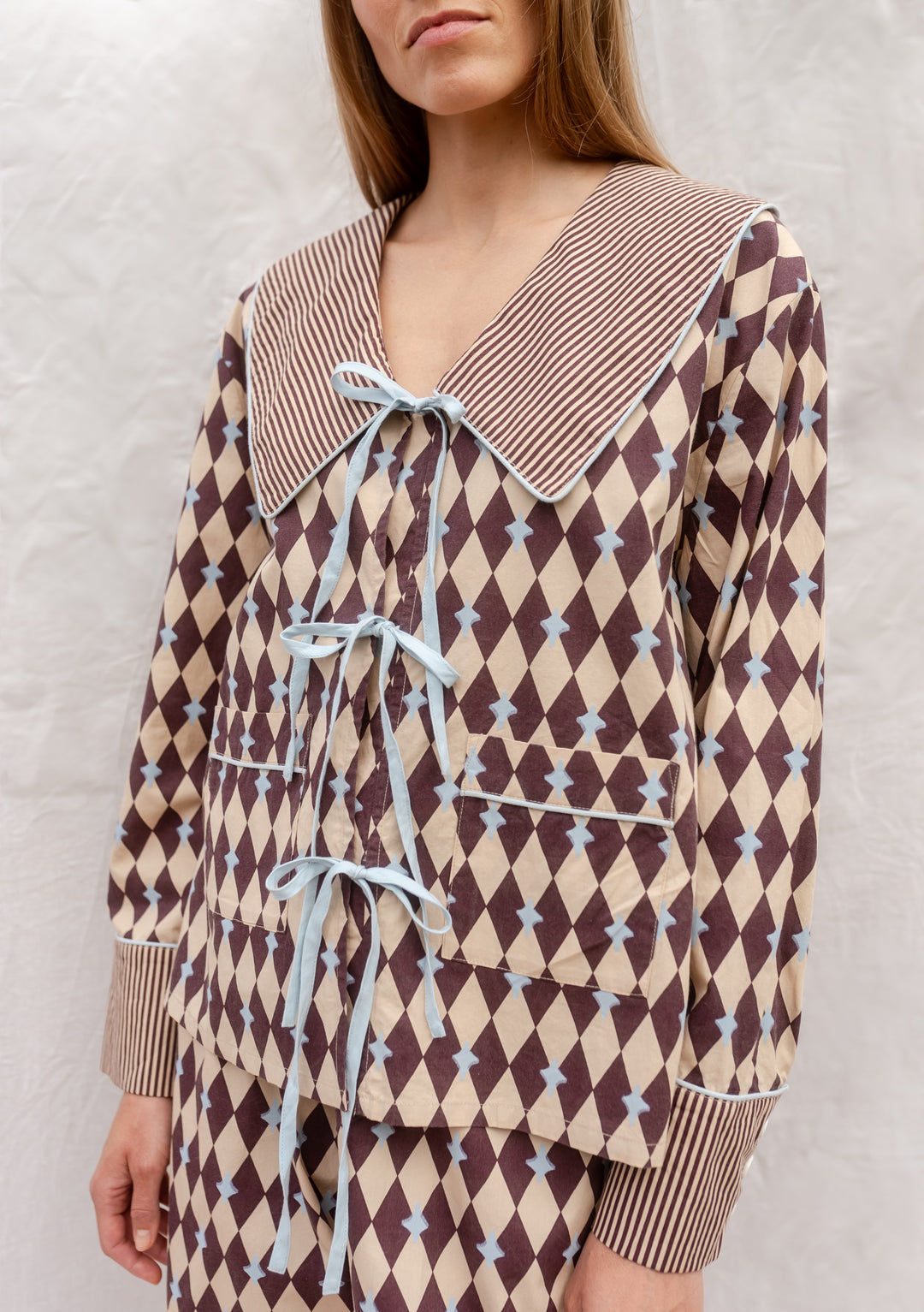 Cotton Pyjamas in Camel Harlequin by TBCo with breathable cotton, blue bows, striped collar, and pockets for everyday comfort.