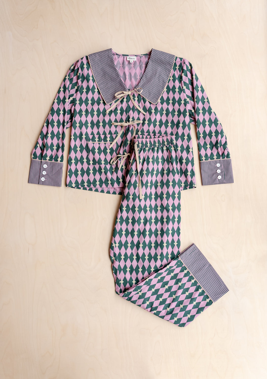 Cotton Pyjamas in Pink Harlequin by TBCo with breathable cotton, contrasting camel bows, striped collar, and elastic waistband.