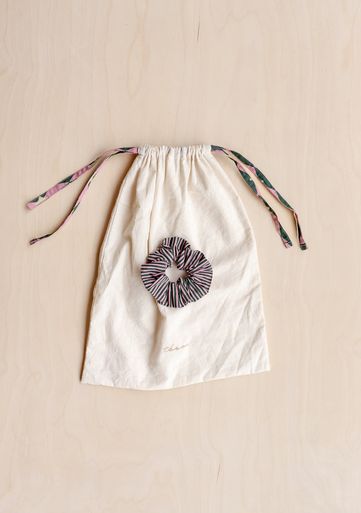 Cotton drawstring bag with matching striped scrunchie for TBCo Cotton Pyjamas in Pink Harlequin storage.