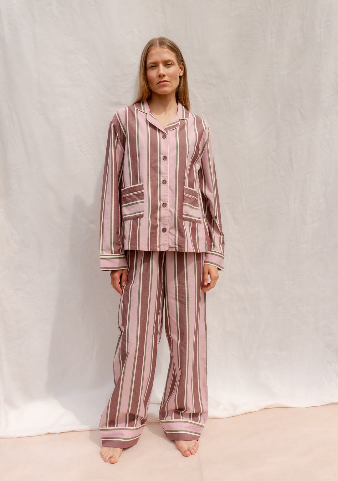 Model wearing TBCo Cotton Pyjamas in Pink Stripe made from breathable cotton with elastic waistband and pockets.
