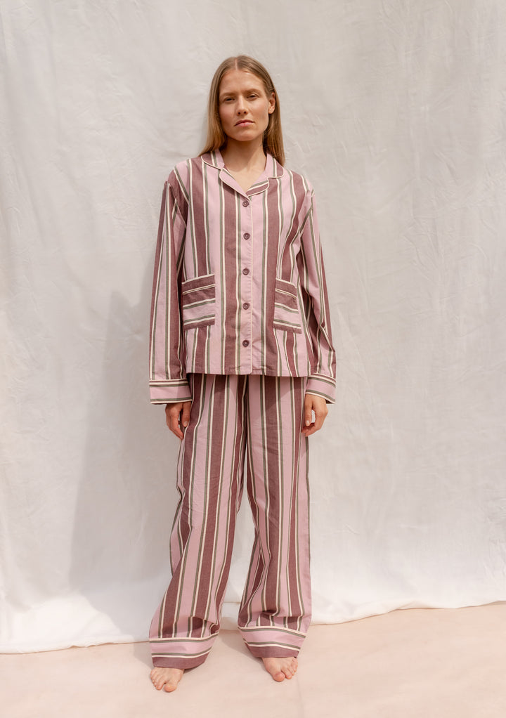 Model wearing TBCo Cotton Pyjamas in Pink Stripe made from breathable cotton with elastic waistband and pockets.