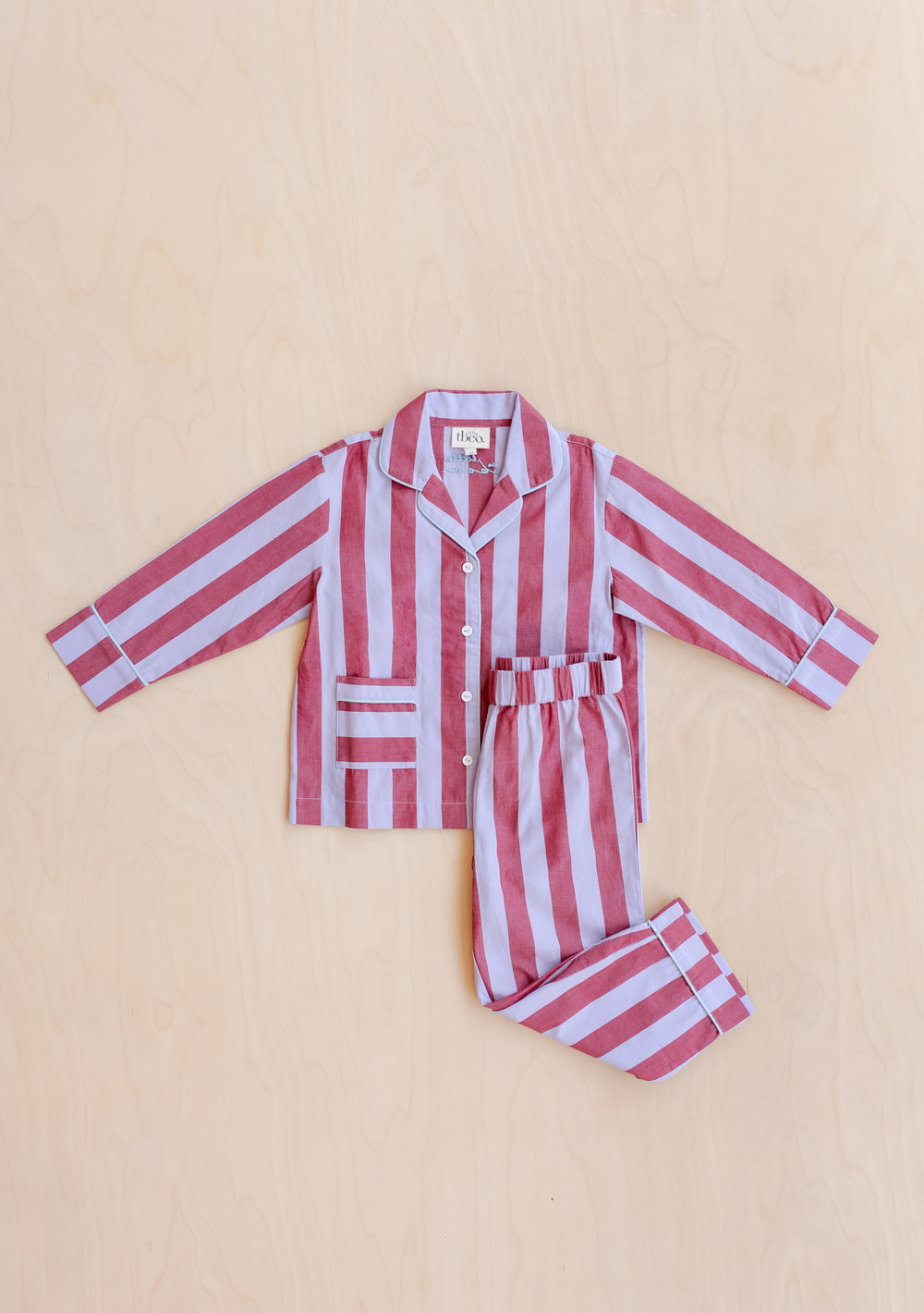 Cotton Kids Pyjamas in Lilac Stripe by TBCo with pink lilac stripes, patch pockets, and breathable 100% cotton fabric.
