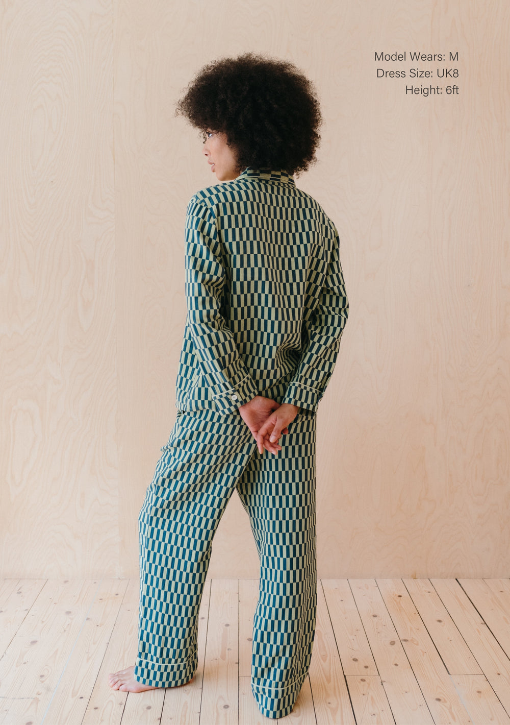 Person wearing TBCo Cotton Pyjamas in Green Checkerboard pattern, showing back view of oversized fit and full-length design