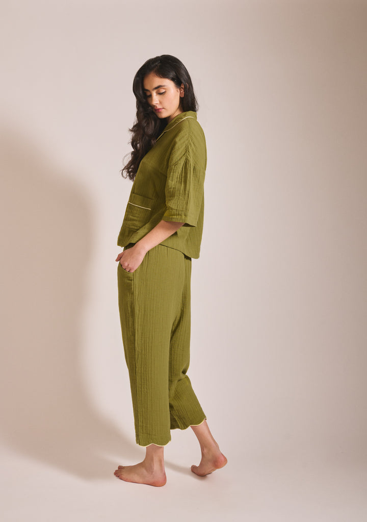 Model in portrait shot wearing TBCo Cropped Cotton Pyjamas in Green with yellow piping, gallery position 3