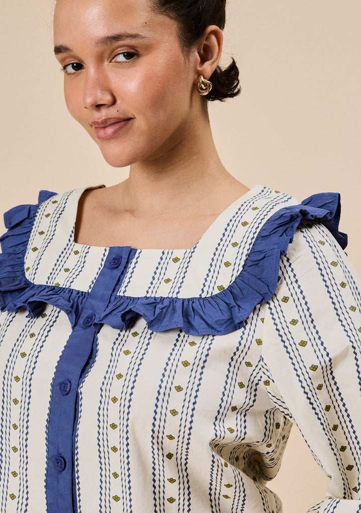 Model wearing TBCo Cropped Cotton Pyjamas in Navy Ditsy Floral with blue ruffle collar and button-front detail