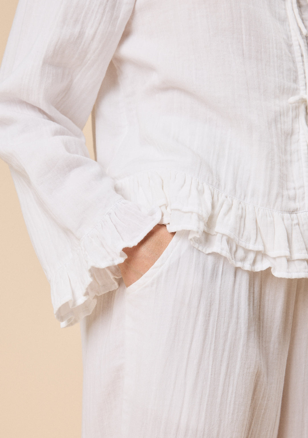 Close-up of TBCo Ankle Grazer Cotton Pyjamas in White Ruffle showcasing breathable natural and recycled fibres, Certified B-Corp, women-founded.