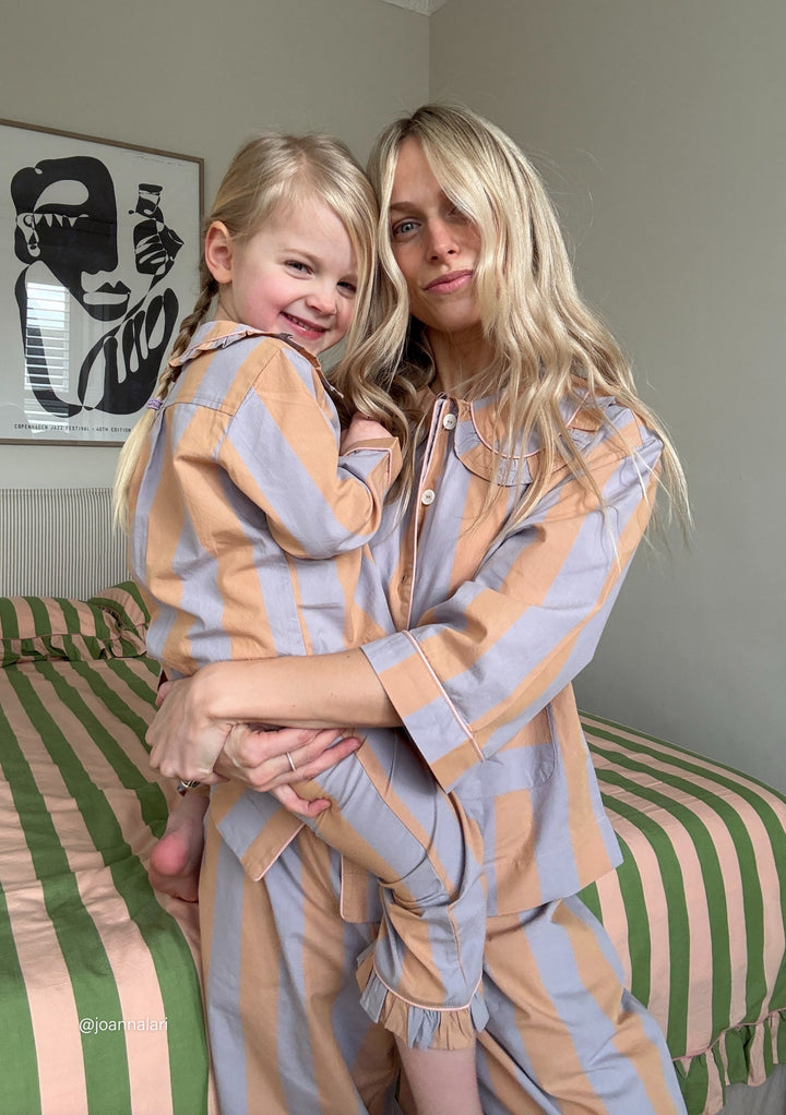 Cotton pyjamas in orange stripe from TBCo featuring ruffle details and 3/4 sleeves, shown in matching adult and child sizes