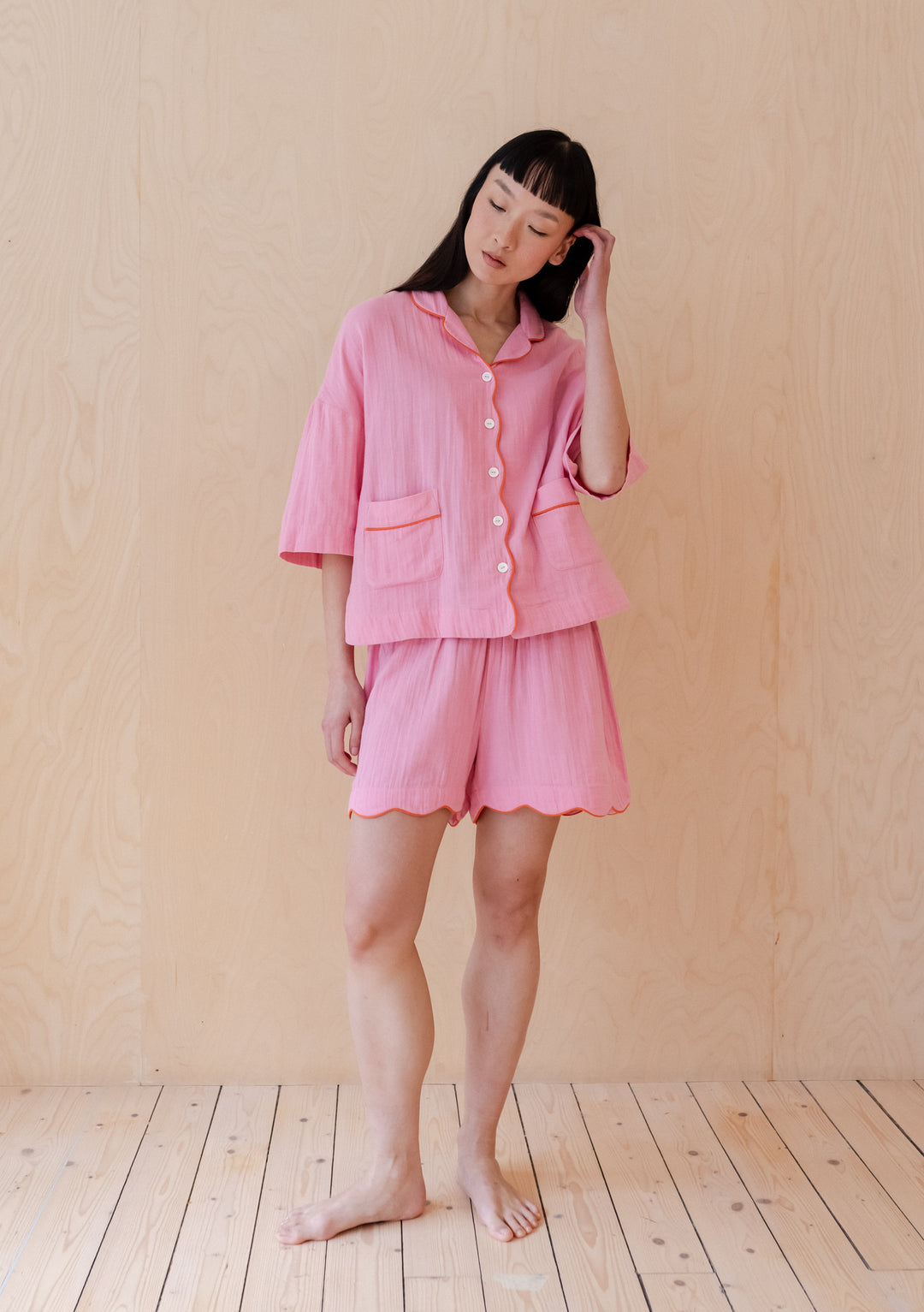 TBCo Cotton Pyjamas in Pink Scallop featuring orange piping and scalloped edges, shown as a short set with button-up top