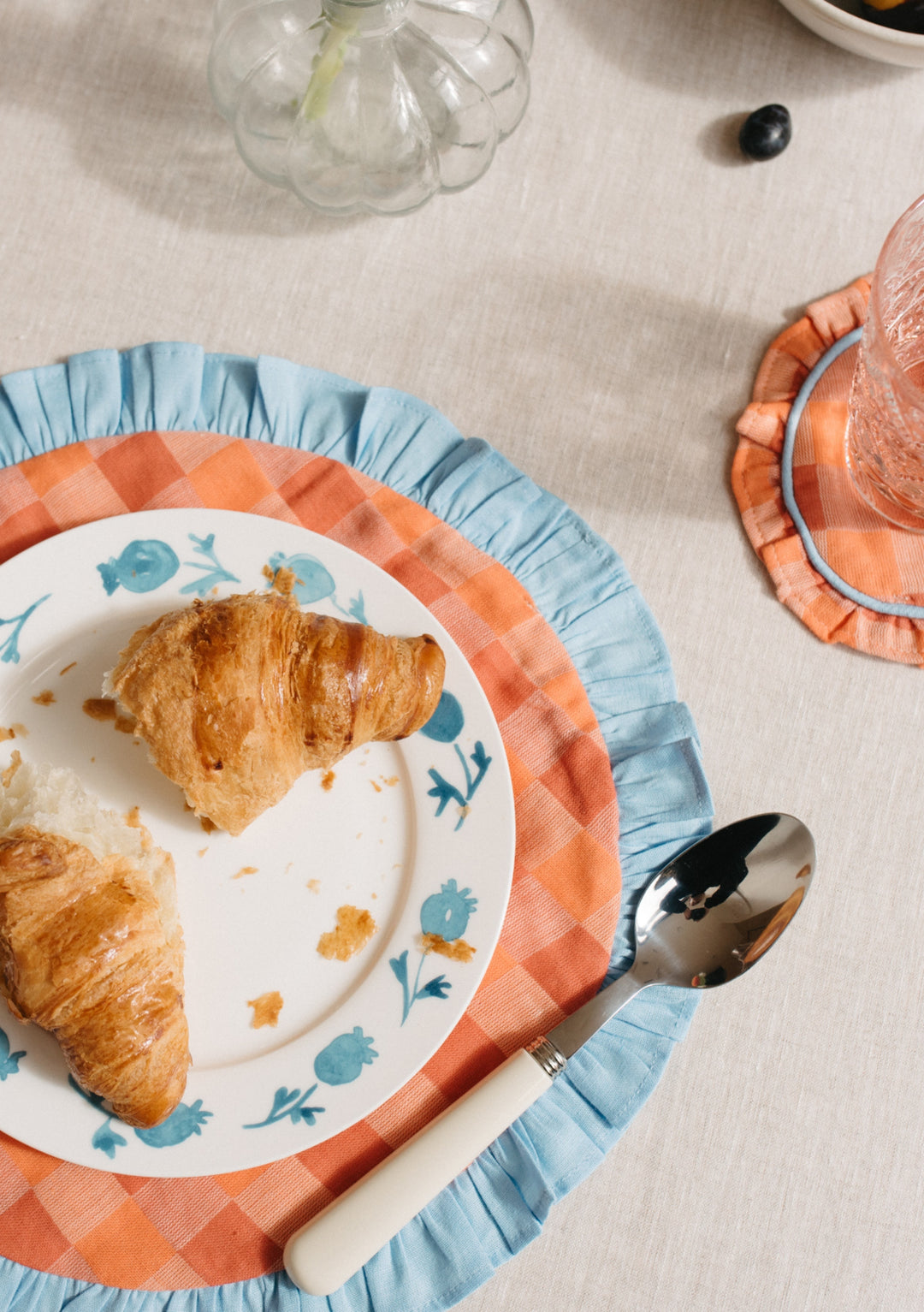 TBCo Cotton Placemats Set of 2 featuring apricot checkerboard pattern with blue ruffle trim on circular table setting