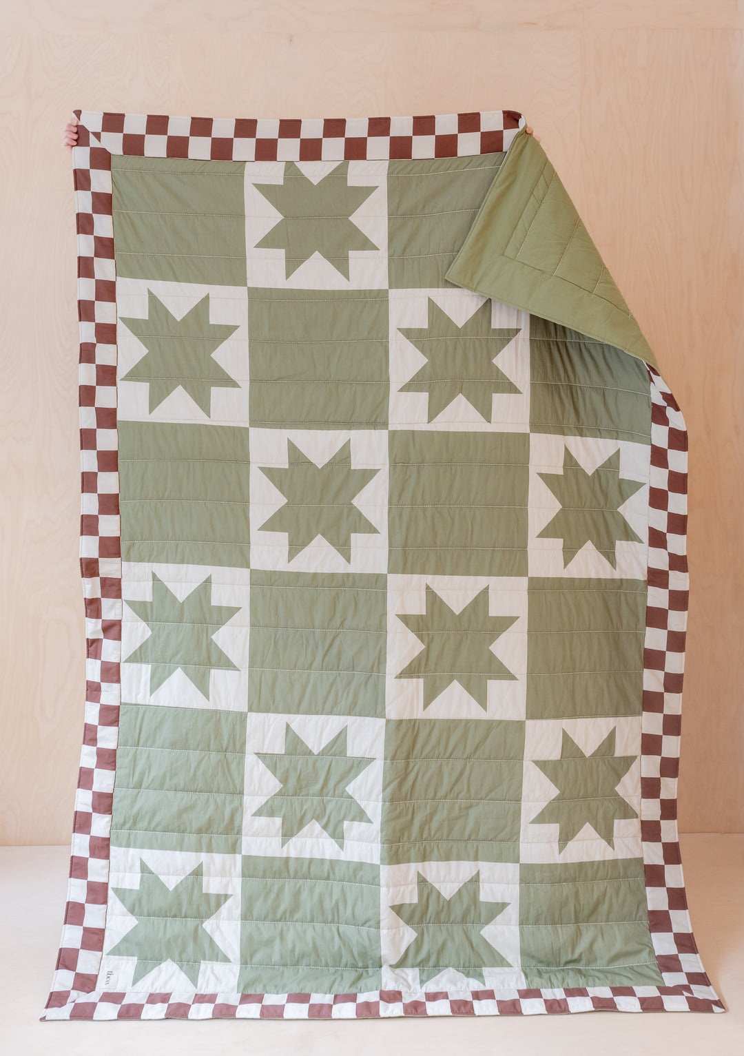 TBCo Quilted Cotton Throw in green and cream celestial checkerboard pattern with star motifs and brown border