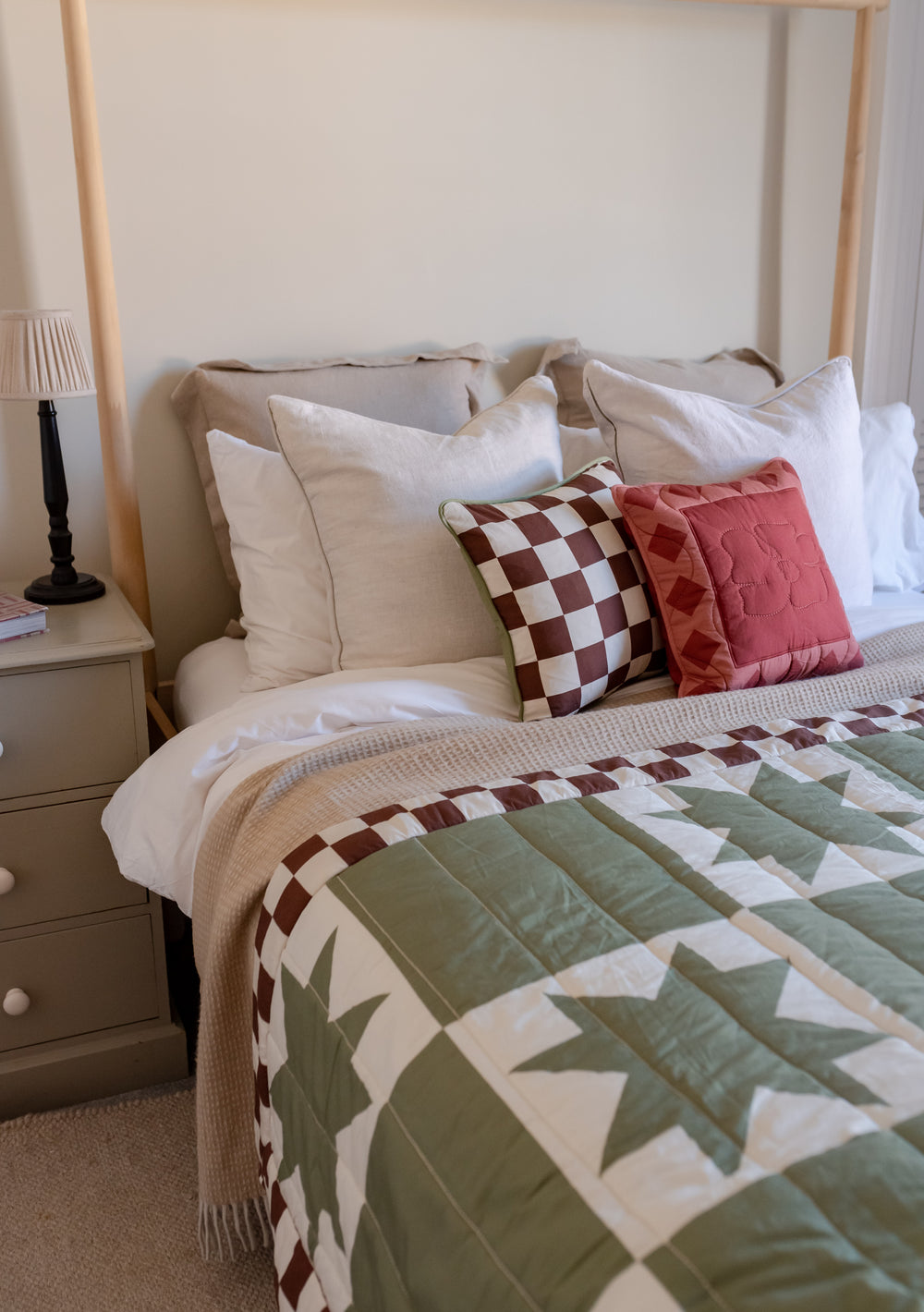 TBCo Celestial Checkerboard quilted cotton throw displayed on bed with matching cushions, featuring green and brown pattern