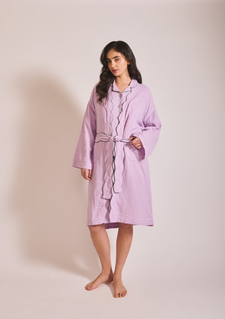 Portrait of model wearing TBCo Cotton Robe in Lilac with scalloped edges and belt, gallery position 1, 1442x2048px