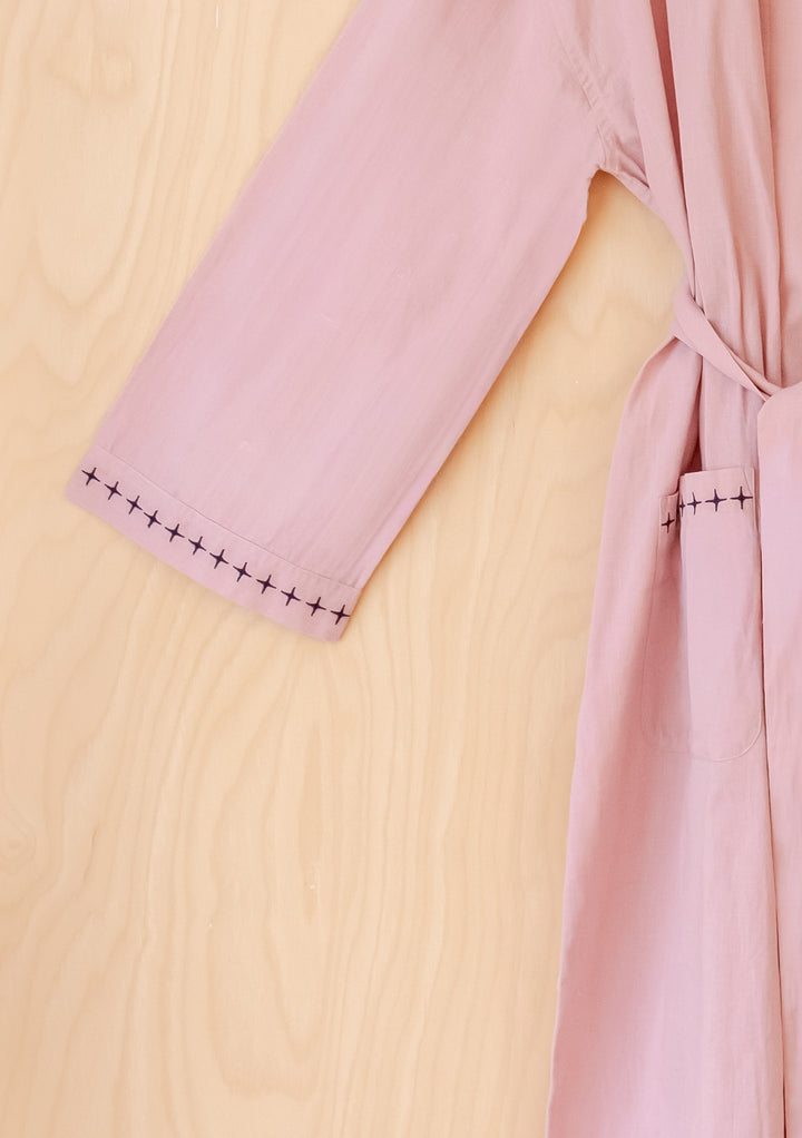 Portrait image of TBCo Cotton & Linen Robe in Pink showing sleeve and embroidered hem detail, gallery position 6