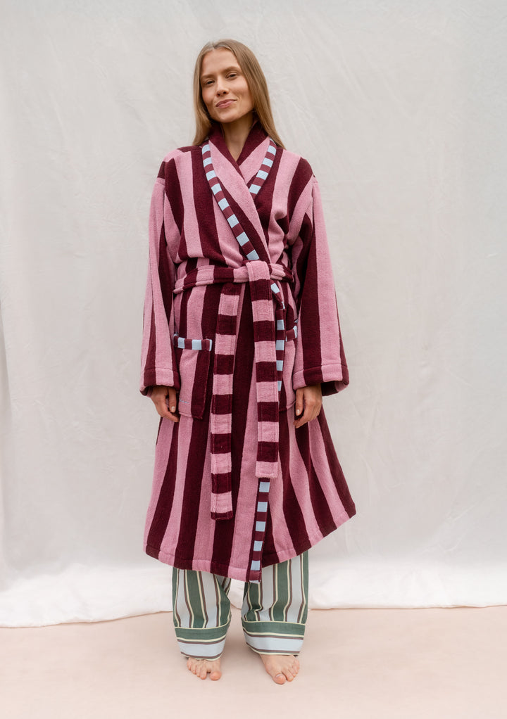 Woman wearing TBCo Cotton Bath Robe in Burgundy Stripe with pockets and sash, lightweight and quick-drying cotton design.