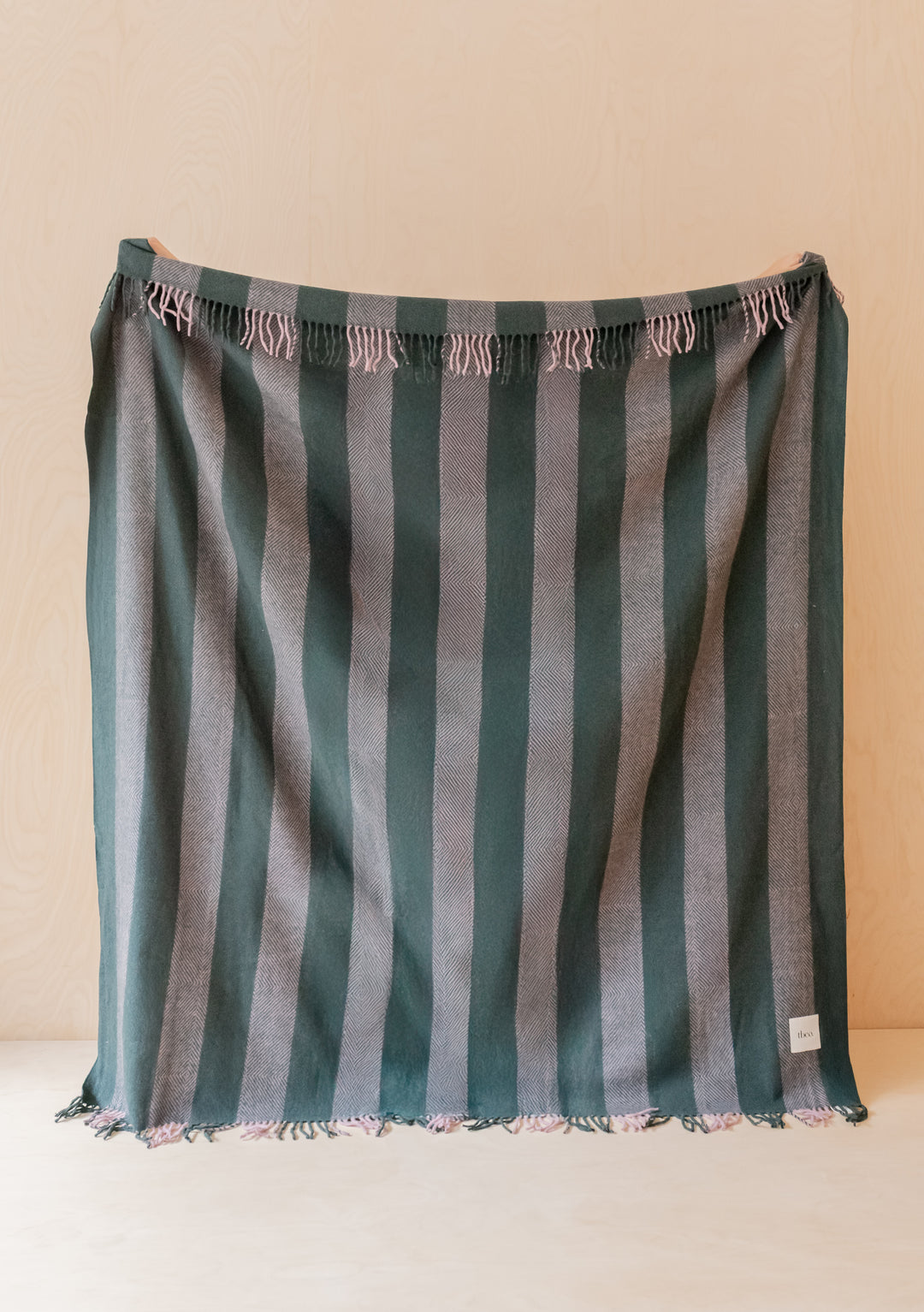 TBCo Sample Sale Recycled Wool Blanket in Pink Diamond Stripe with green and pink striped fringed design hanging flat