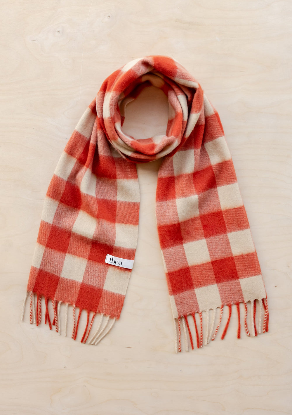 TBCo Lambswool Scarf in Orange Gingham features cream and orange checkered pattern with fringed ends, made from soft lambswool