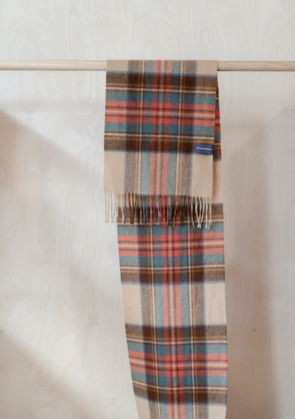 TBCo Stewart Dress Antique Tartan Lambswool Scarf draped over wooden rail showing plaid pattern and fringed edges